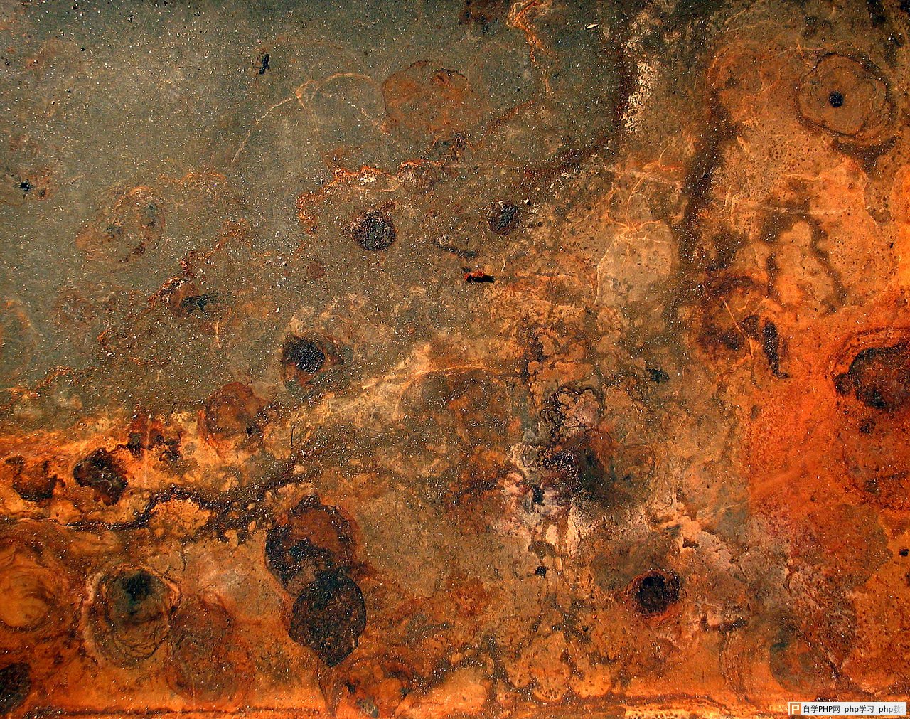 A photograph of rust and dirt.